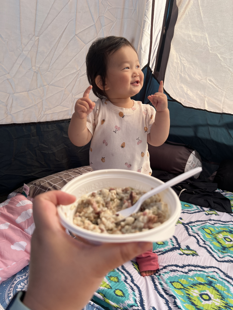 Maddy enjoying her jook! 10/10 recommend as it's easy to heat up and delicious!